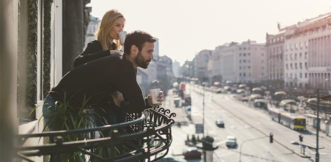 Man and Woman looking over a balcony